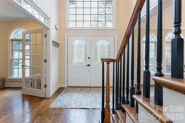 a view of an entryway with wooden floor and door