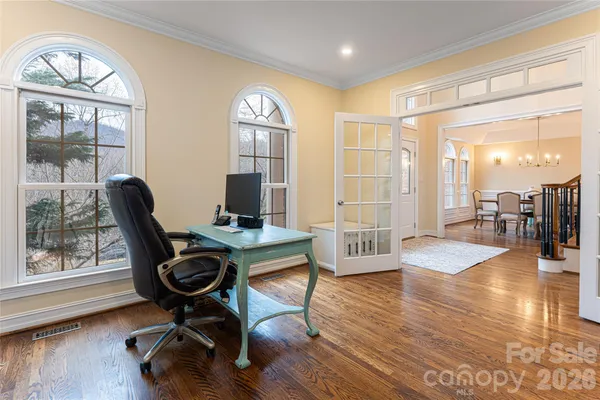a workspace with wooden floor and a window