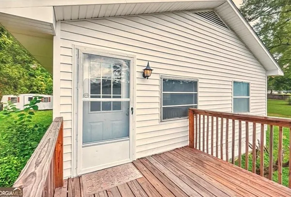 a view of a balcony with wooden floor and fence