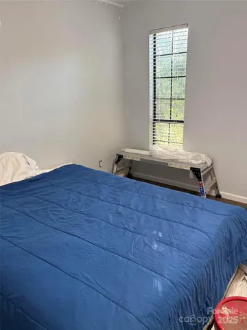 a bed sitting in a bedroom next to a window