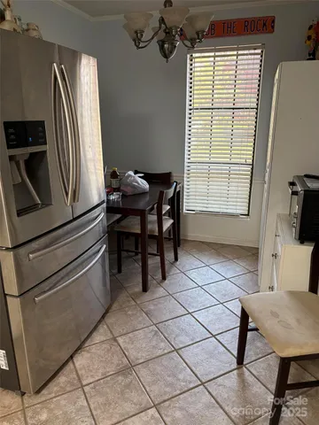 a kitchen with stainless steel appliances granite countertop a sink and a refrigerator