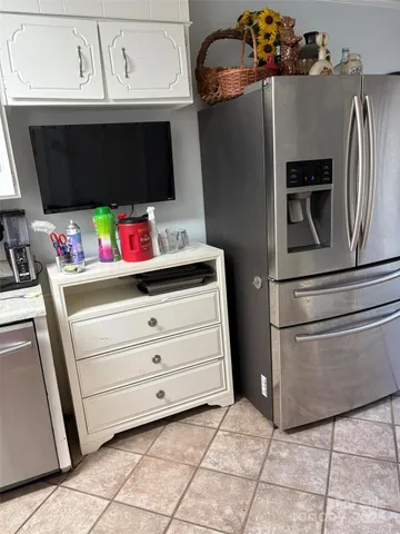 a kitchen with a refrigerator and cabinets