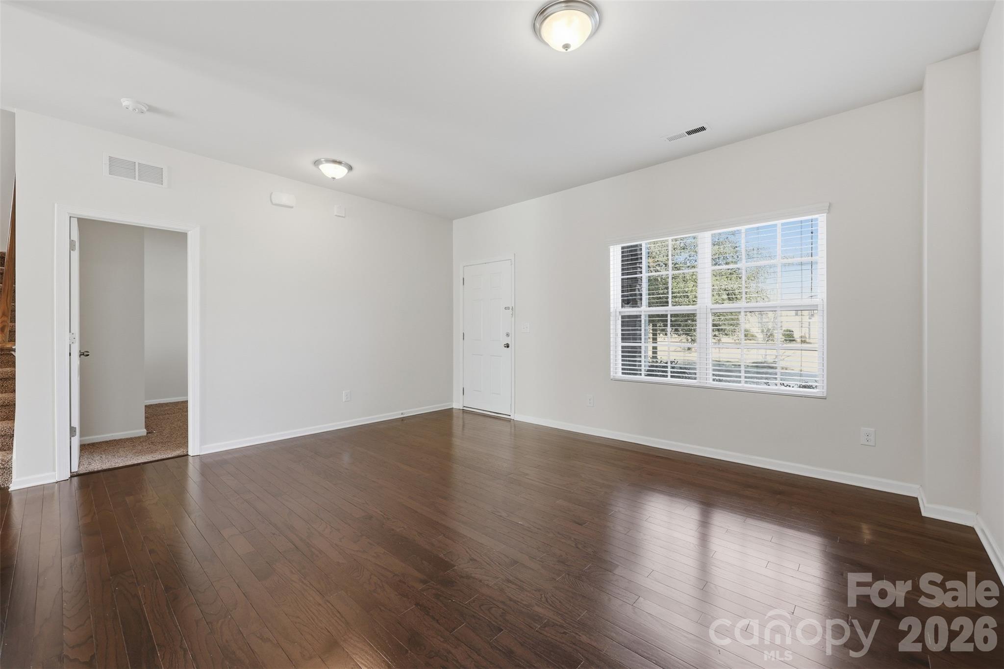 1722 Still River Way Fort Mill, SC 29708 - Photo 12 of 45 an empty room with wooden floor and windows