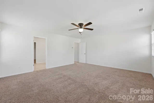 a view of a livingroom with a ceiling fan and window
