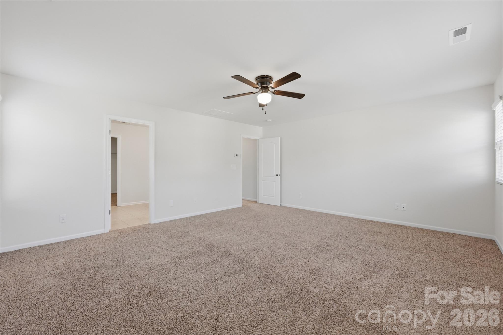 1722 Still River Way Fort Mill, SC 29708 - Photo 20 of 45 a view of an empty room with a ceiling fan