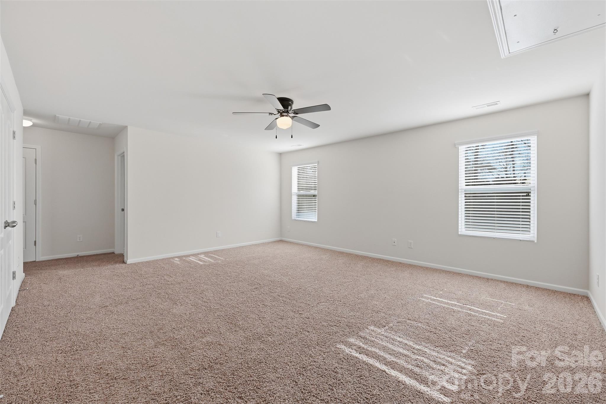 1722 Still River Way Fort Mill, SC 29708 - Photo 22 of 45 an empty room with windows and ceiling fan