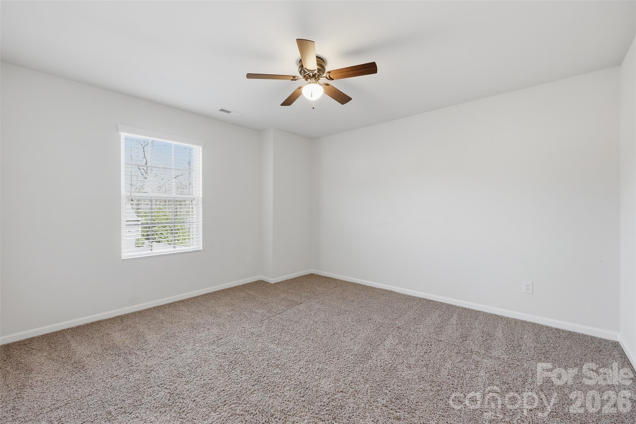 1722 Still River Way Fort Mill, SC 29708 - Photo 34 of 45 an empty room with a window and a fan