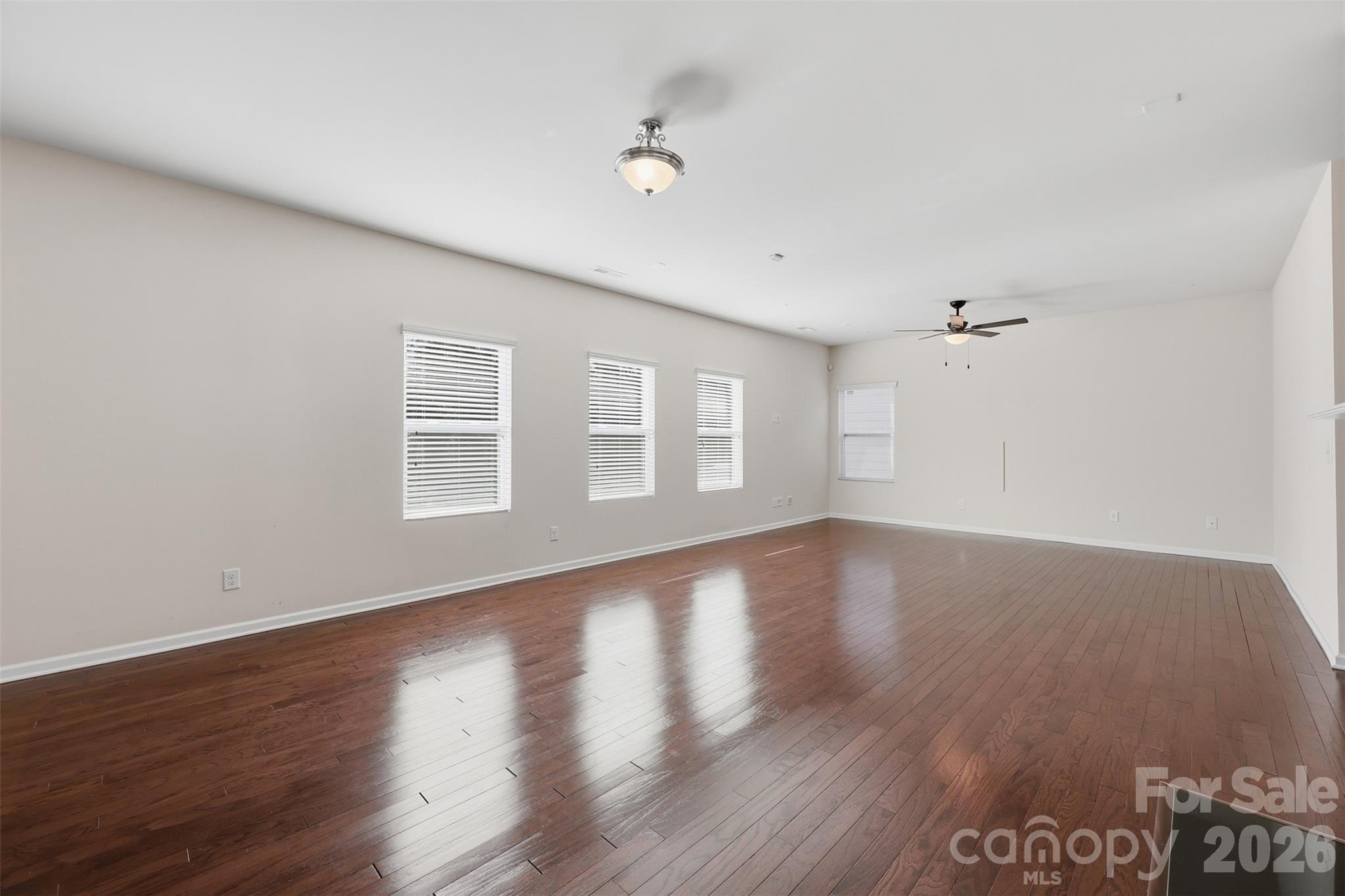 1722 Still River Way Fort Mill, SC 29708 - Photo 6 of 45 a view of an empty room with wooden floor and a window