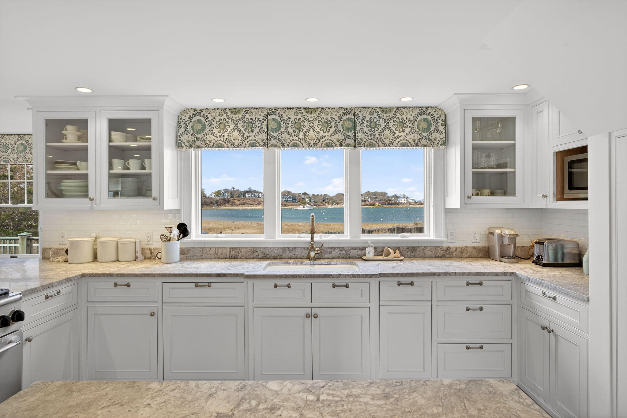 346 Morris Island Road Chatham, MA 02633 - Photo 8 of 33 a kitchen with a sink window and cabinets