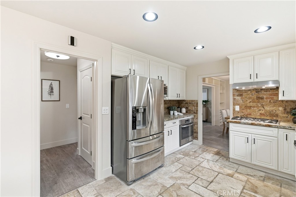 21630 Edward Way Cupertino, CA 95014 - Photo 14 of 59 a kitchen with white cabinets and stainless steel appliances