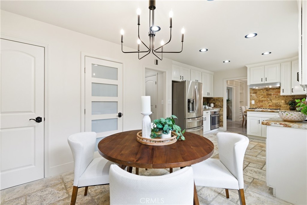 21630 Edward Way Cupertino, CA 95014 - Photo 15 of 59 a view of a dining room with furniture a chandelier and wooden floor