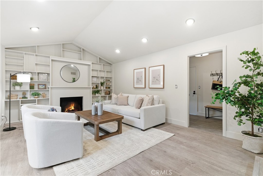 21630 Edward Way Cupertino, CA 95014 - Photo 17 of 59 a living room with furniture a fireplace and a potted plant
