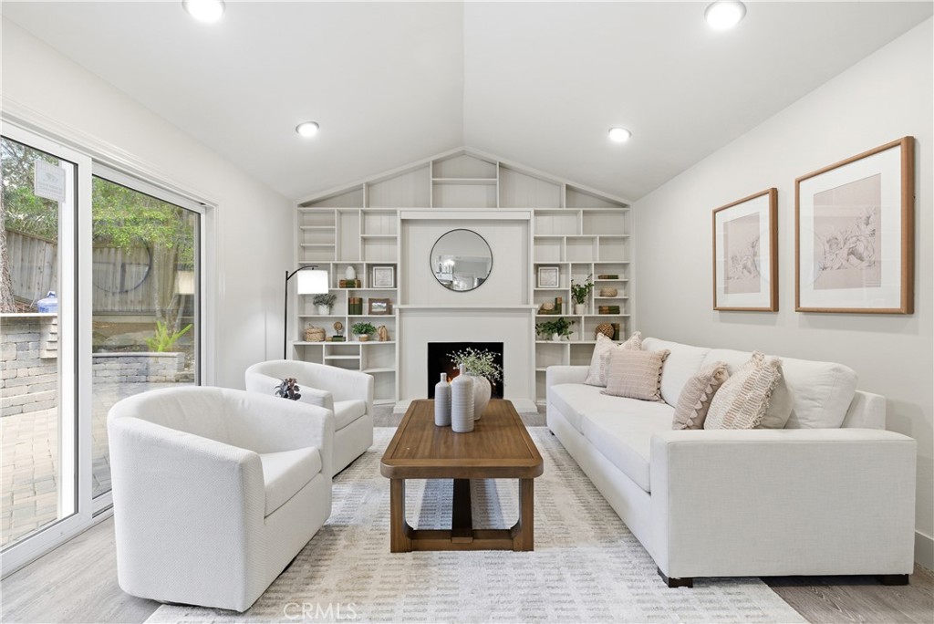 21630 Edward Way Cupertino, CA 95014 - Photo 18 of 59 a living room with furniture a fireplace and a large window