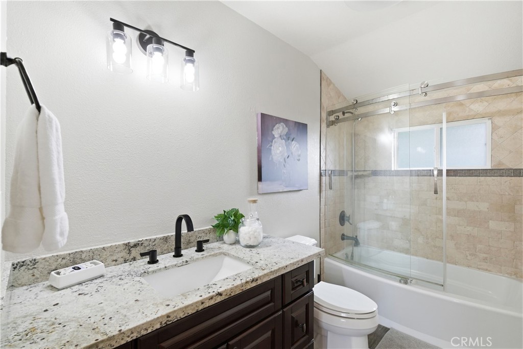 21630 Edward Way Cupertino, CA 95014 - Photo 26 of 59 a bathroom with a granite countertop sink toilet and shower