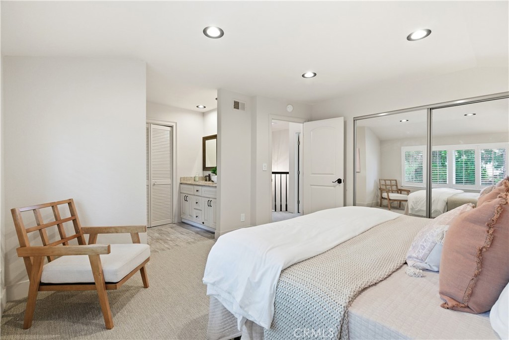 21630 Edward Way Cupertino, CA 95014 - Photo 36 of 59 a spacious bedroom with a bed a couch and a window