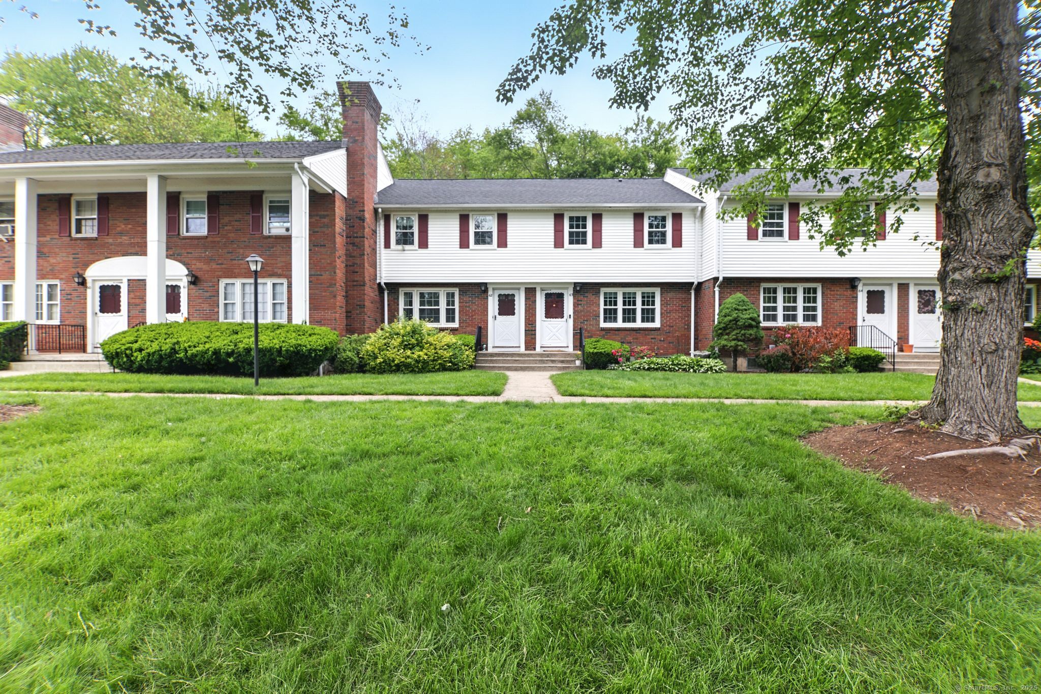 62 Brandywine Lane, Unit 62 Suffield, CT 06078 - Photo 1 of 1 a front view of a house with a garden and porch