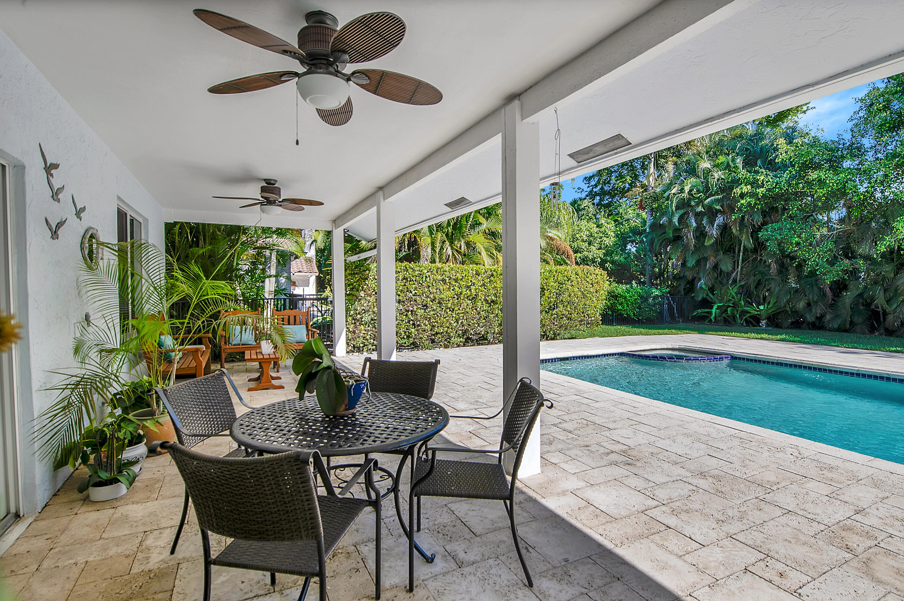 2932 Banyan Blvd Circle Northwest Boca Raton, FL 33431 - Photo 34 of 57 a view of a patio with a table chairs and a backyard