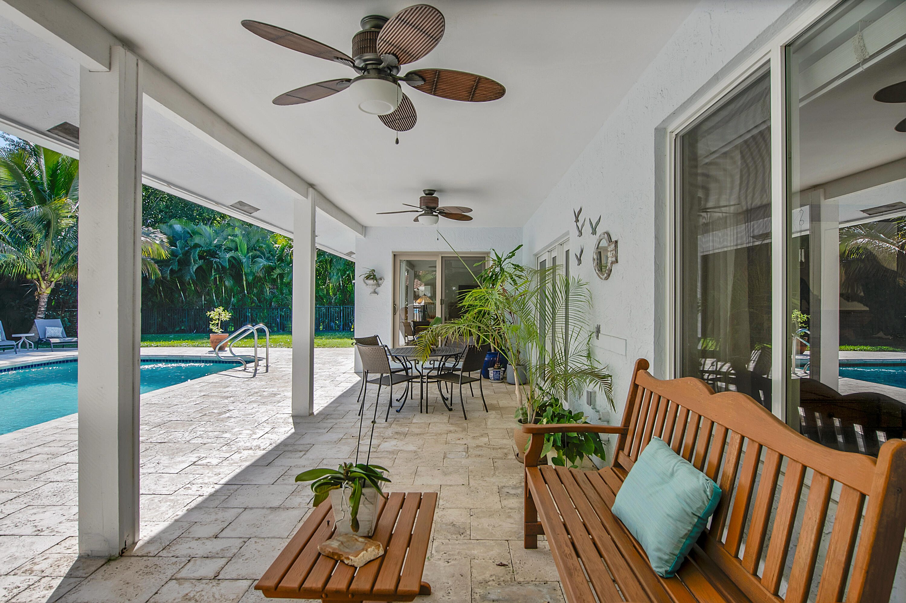 2932 Banyan Blvd Circle Northwest Boca Raton, FL 33431 - Photo 35 of 57 a view of a patio with dining table and chairs