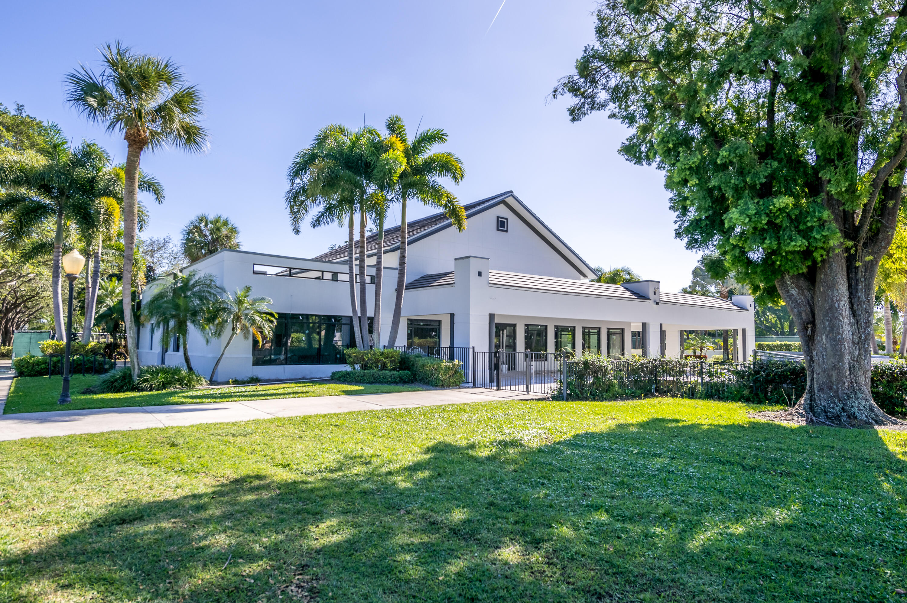 2932 Banyan Blvd Circle Northwest Boca Raton, FL 33431 - Photo 43 of 57 a front view of a house with a yard and palm trees