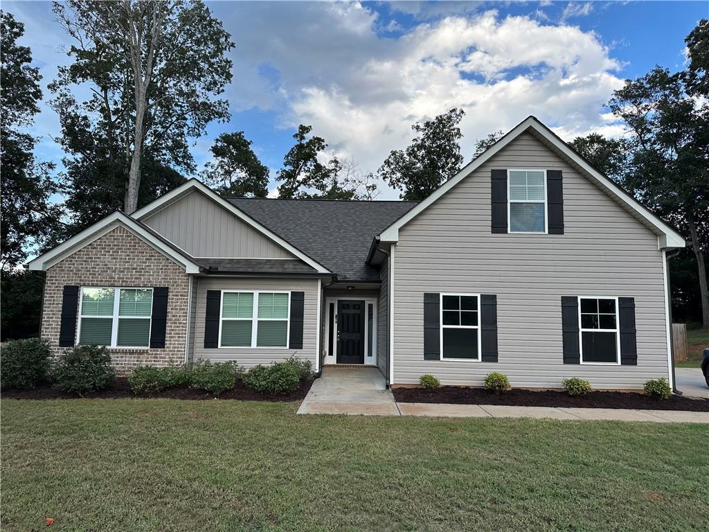 5240 Sandy Cross Road Carnesville, GA 30521 - Photo 1 of 1 a front view of a house with a garden