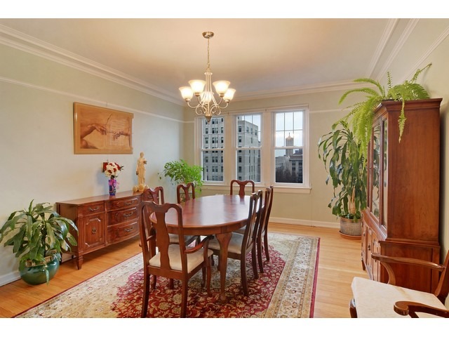 6342 North Sheridan Road, Unit 5B Chicago, IL 60660 - Photo 13 of 25 a view of a dining room with furniture and a chandelier