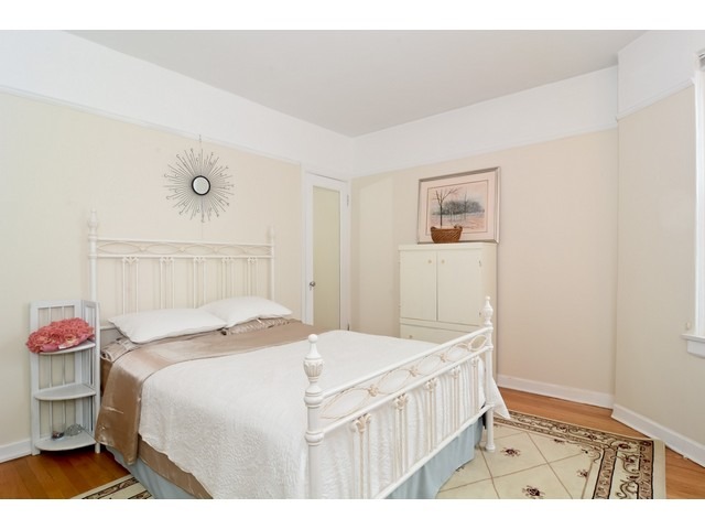 6342 North Sheridan Road, Unit 5B Chicago, IL 60660 - Photo 15 of 25 a bedroom with a bed and a table