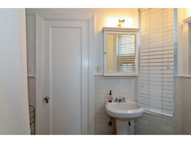 6342 North Sheridan Road, Unit 5B Chicago, IL 60660 - Photo 21 of 25 a bathroom with a sink a mirror and a shower