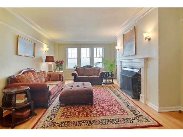 6342 North Sheridan Road, Unit 5B Chicago, IL 60660 - Photo 3 of 25 a living room with furniture hard wood floor and a fireplace