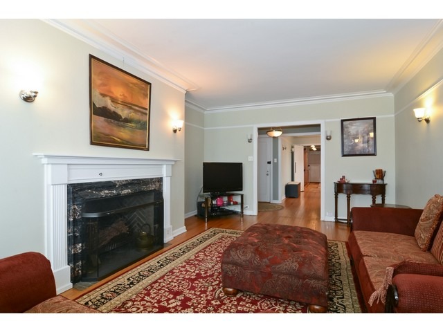 6342 North Sheridan Road, Unit 5B Chicago, IL 60660 - Photo 5 of 25 a living room with furniture a flat screen tv and a fireplace