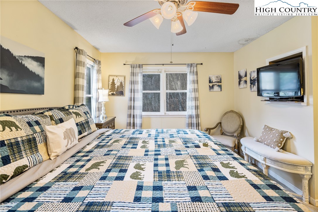 2408 Todd Railroad Grade Road Todd, NC 28684 - Photo 22 of 46 a bedroom with a bed and wooden floor