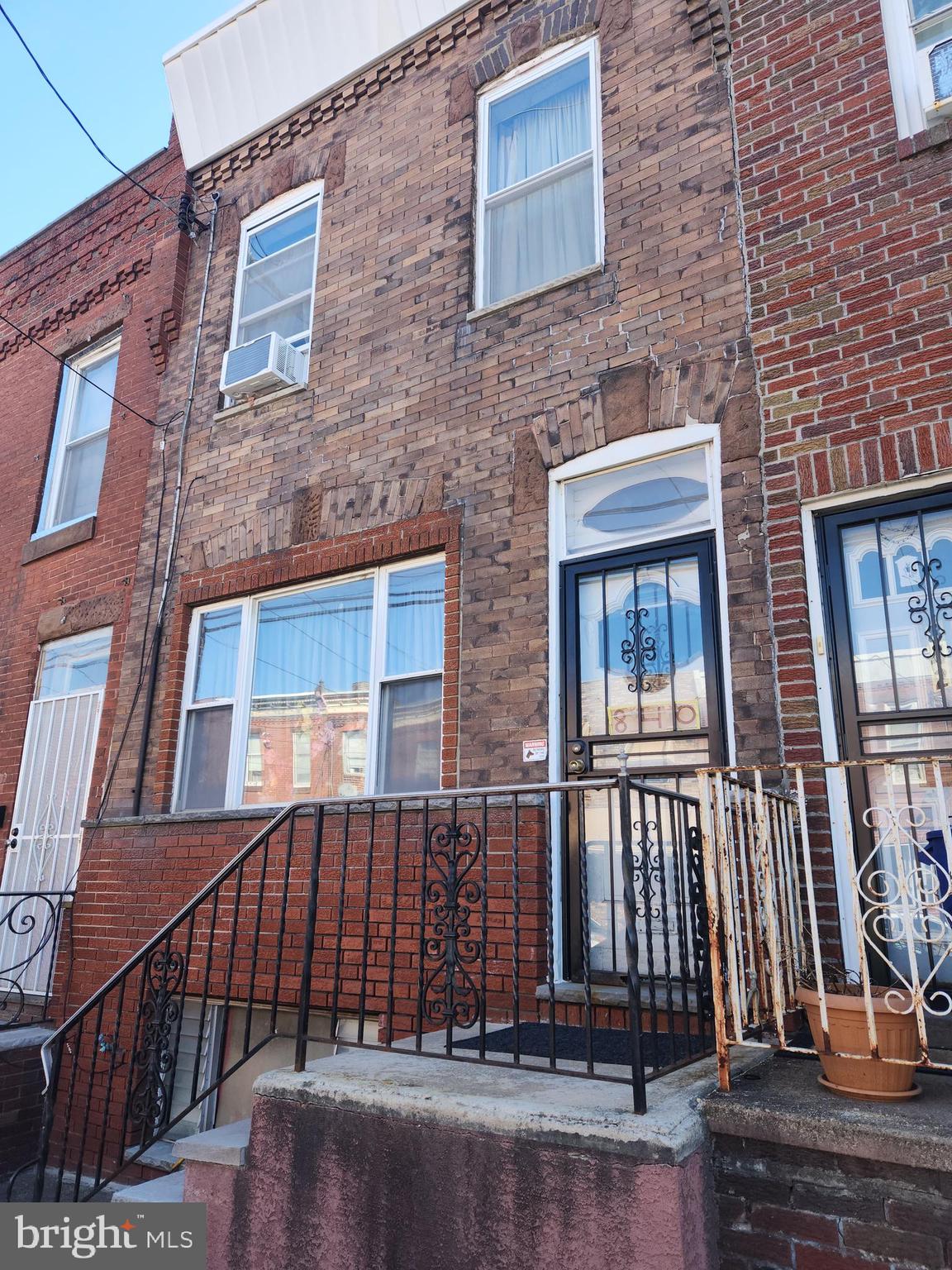 a front view of a house with a fence