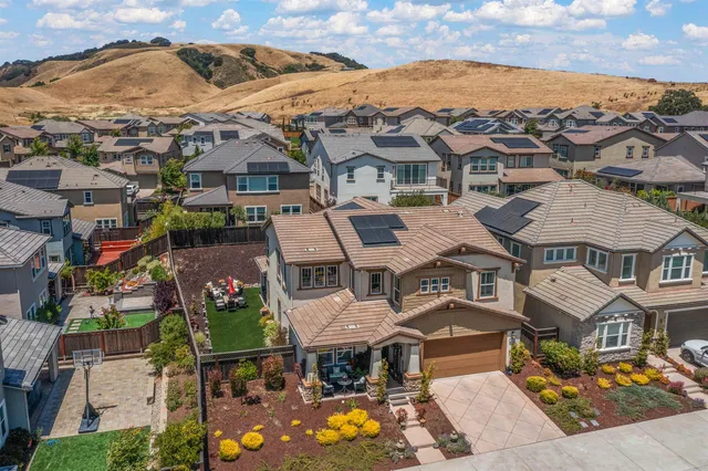 an aerial view of residential houses with outdoor space