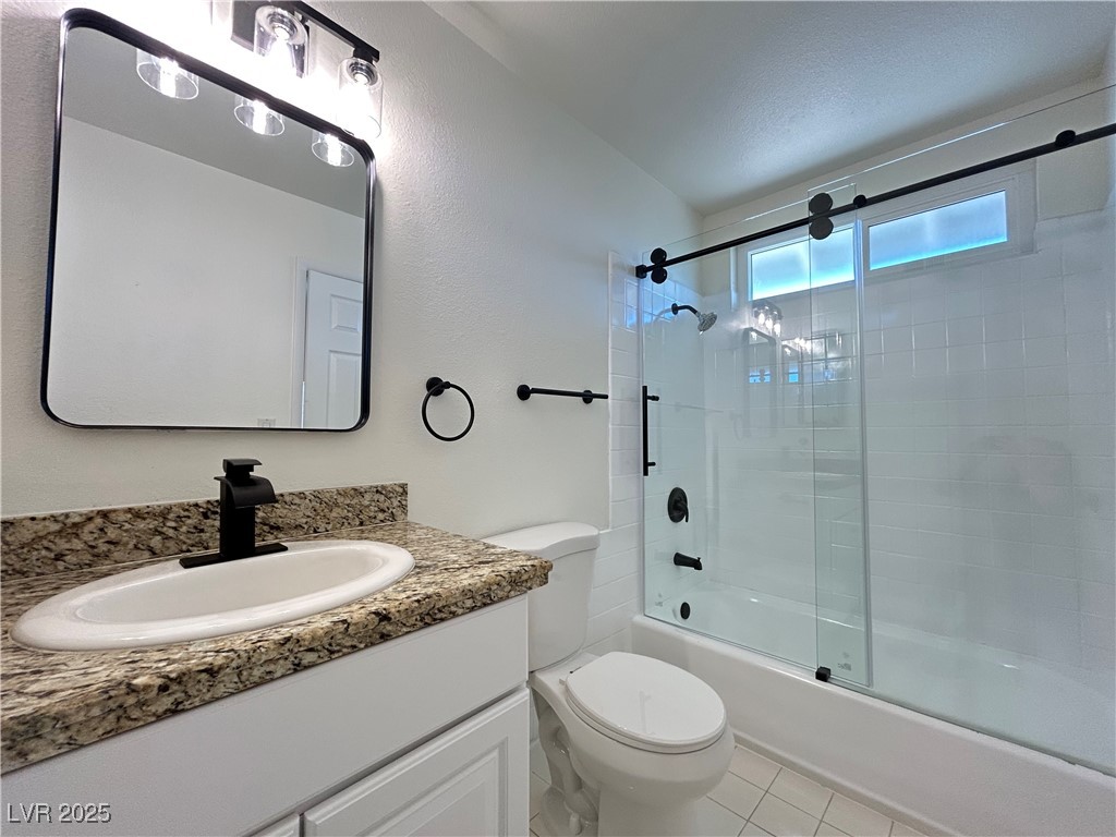 5035 Meadow Grove Court Las Vegas, NV 89120 - Photo 11 of 23 Full bathroom with bath / shower combo with glass door, vanity, and light tile patterned floors