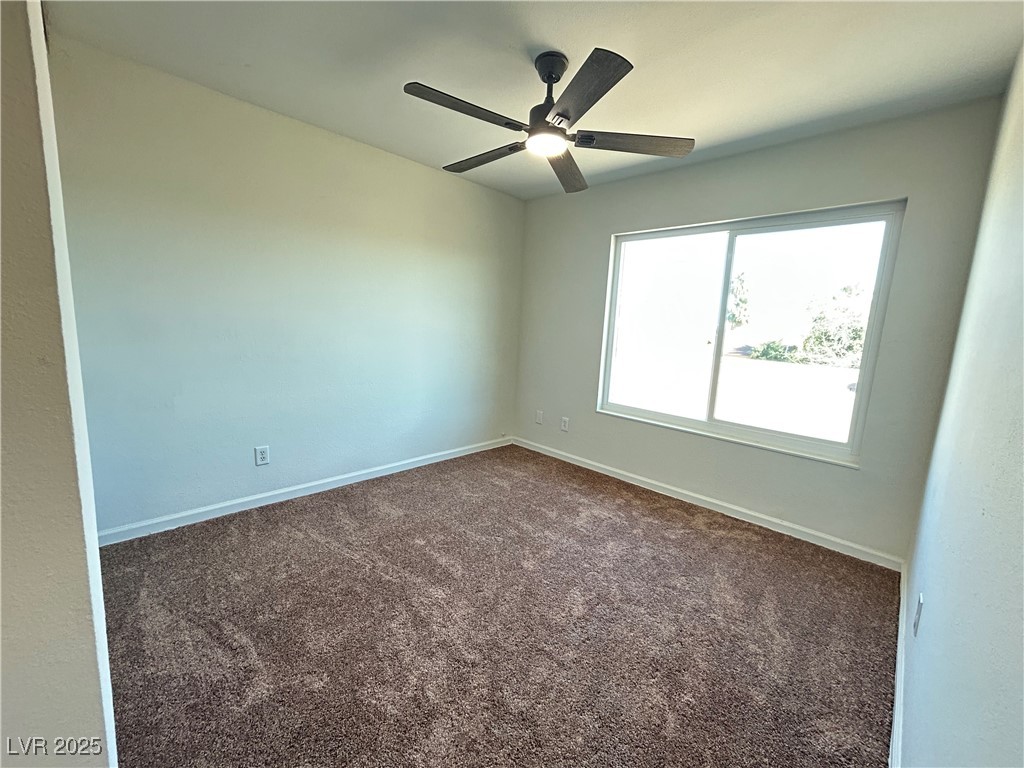 5035 Meadow Grove Court Las Vegas, NV 89120 - Photo 17 of 23 Spare room featuring dark carpet and a ceiling fan