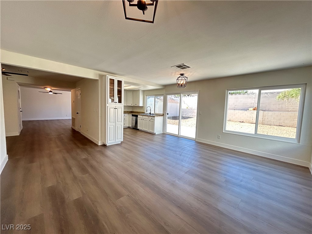 5035 Meadow Grove Court Las Vegas, NV 89120 - Photo 4 of 23 Unfurnished living room with plenty of natural light, dark wood finished floors, and a ceiling fan