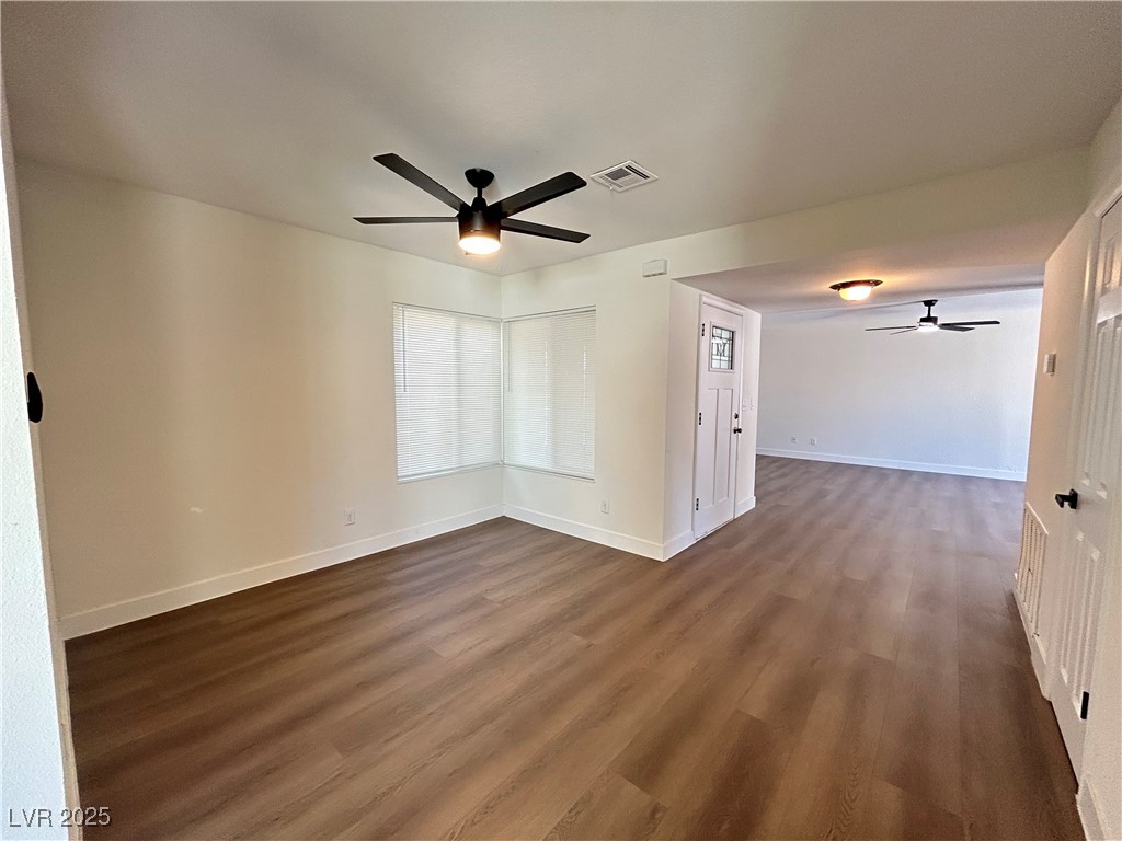 5035 Meadow Grove Court Las Vegas, NV 89120 - Photo 5 of 23 Empty room featuring a ceiling fan and dark wood-style floors