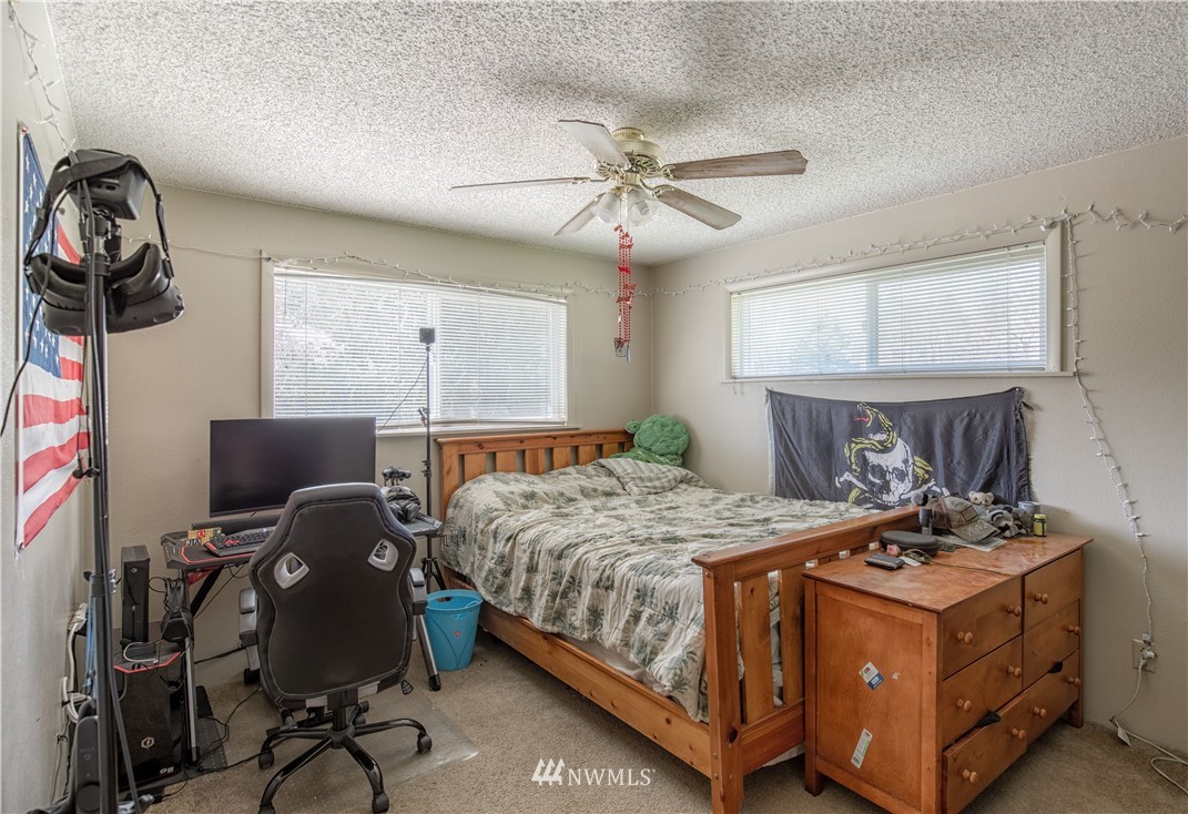 12410 Wagner Road Monroe, WA 98272 - Photo 14 of 30 a bedroom with a bed and a chandelier