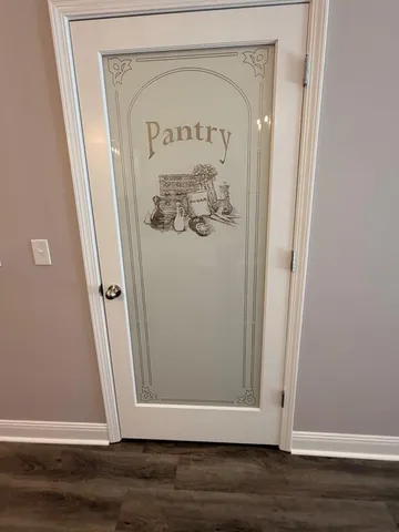 an empty room with a window and a ceiling fan