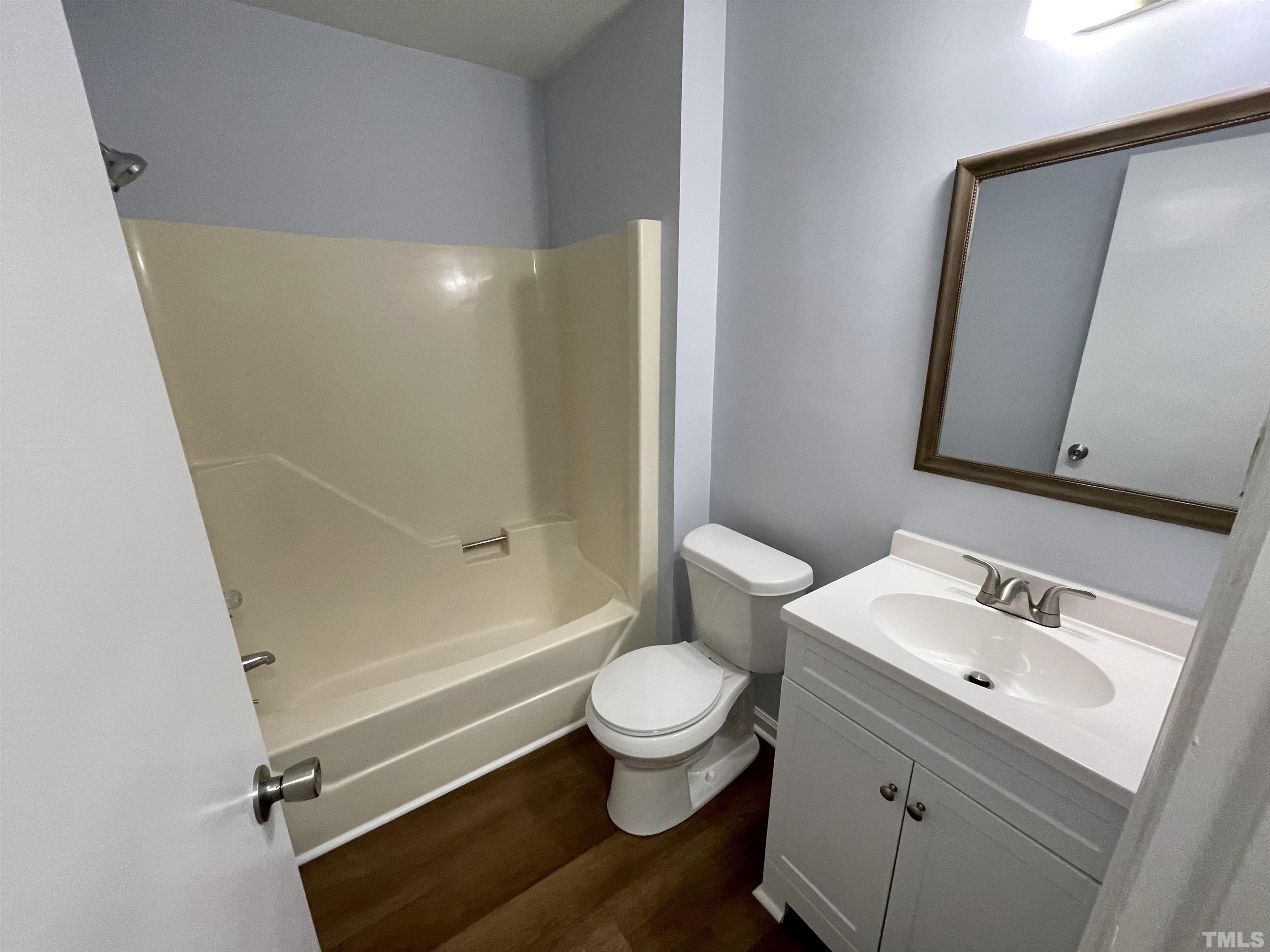 1421 Elm Street Roxboro, NC 27573 - Photo 4 of 13 a bathroom with a sink a toilet and a mirror