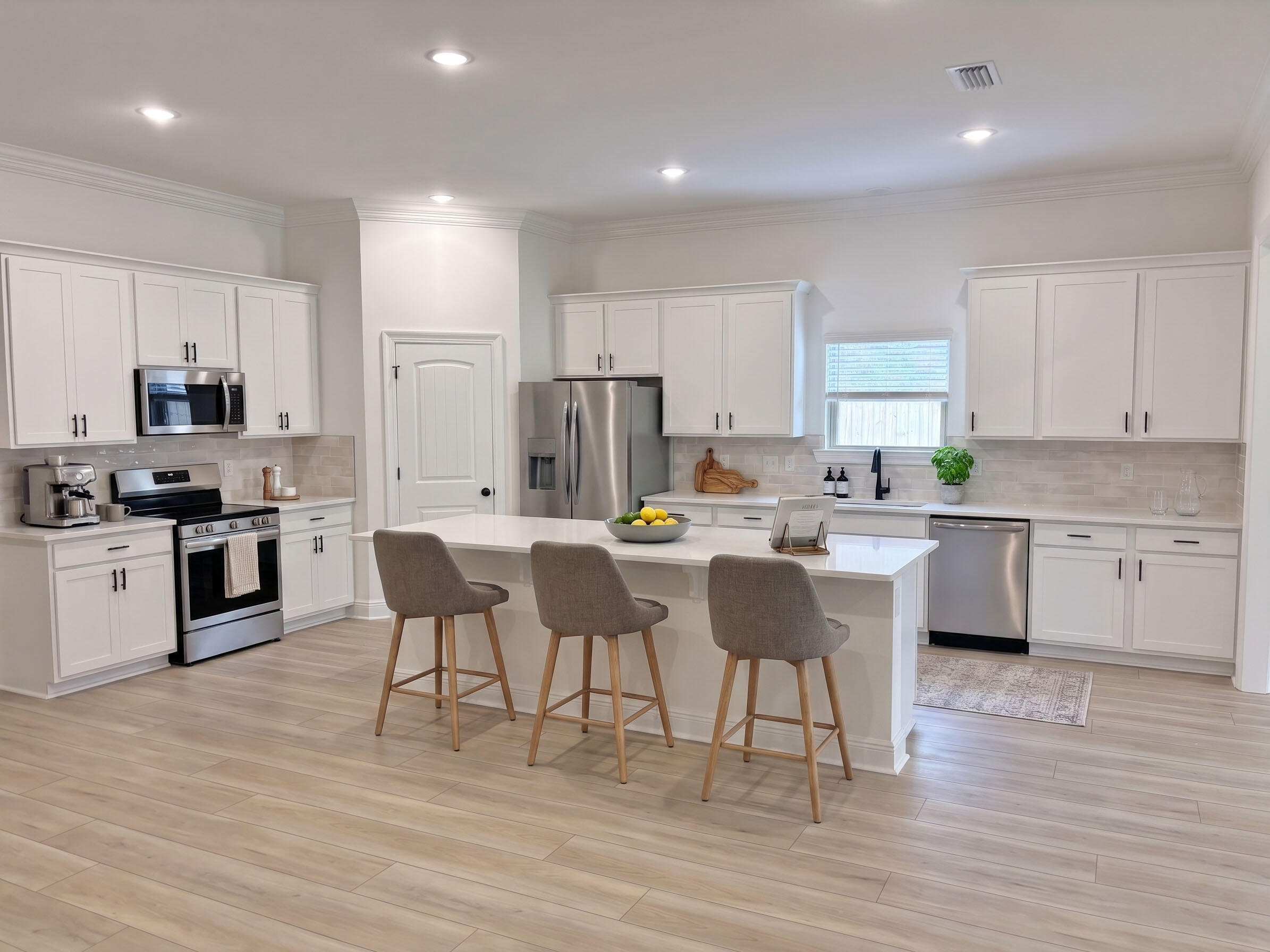 2745 Louis Circle Crestview, FL 32536 - Photo 2 of 18 a kitchen with stainless steel appliances kitchen island granite countertop a stove a sink a refrigerator and white cabinets