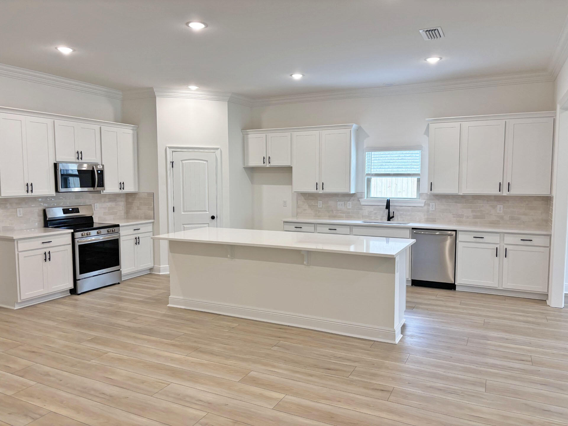 2745 Louis Circle Crestview, FL 32536 - Photo 3 of 18 a kitchen with granite countertop white cabinets and stainless steel appliances