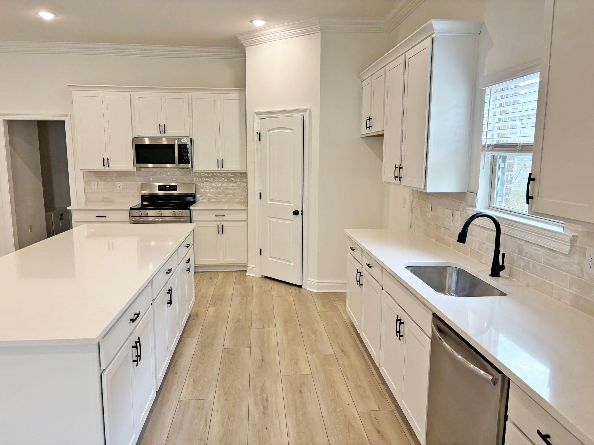 2745 Louis Circle Crestview, FL 32536 - Photo 4 of 18 a kitchen with white cabinets sink and stainless steel appliances