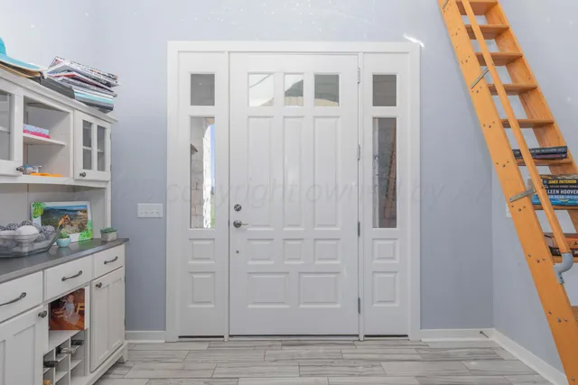 a kitchen with stainless steel appliances kitchen island granite countertop a refrigerator and a stove top oven