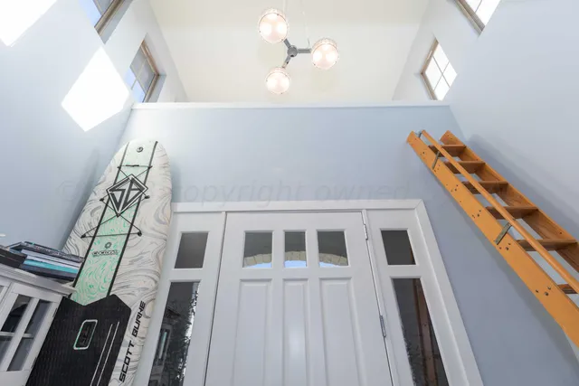 a large white kitchen with granite countertop a stove top oven