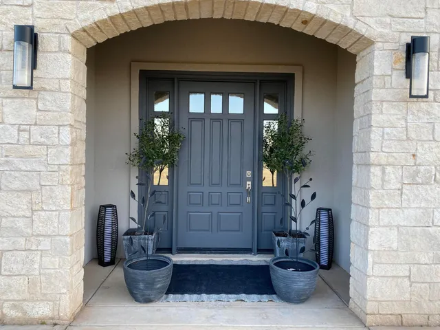 a living room with furniture wooden floor and a large window