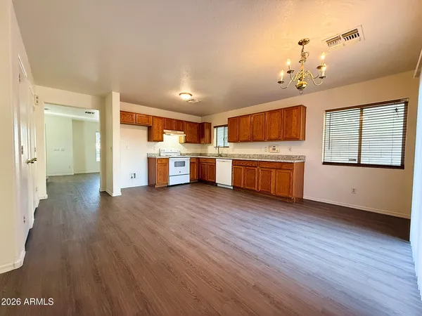 a open kitchen with cabinets and wooden floor