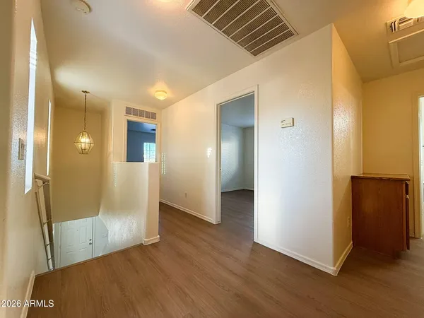 a view of a hallway with wooden floor