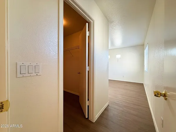 a view of a hallway with wooden floor