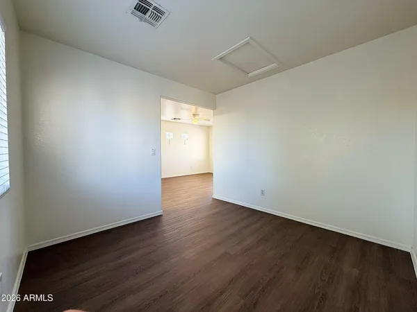 an empty room with wooden floor