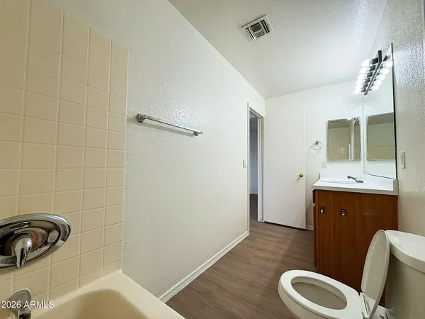 a bathroom with a sink mirror vanity and toilet